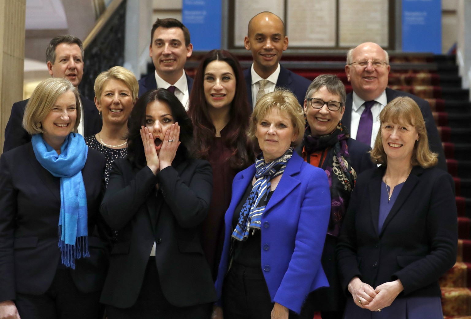 Eleven British lawmakers who have joined new political party &#039;The Independent Group&#039; pose for a photograph after a press conference in Westminster in London, Wednesday, Feb. 20, 2019. Cracks ...