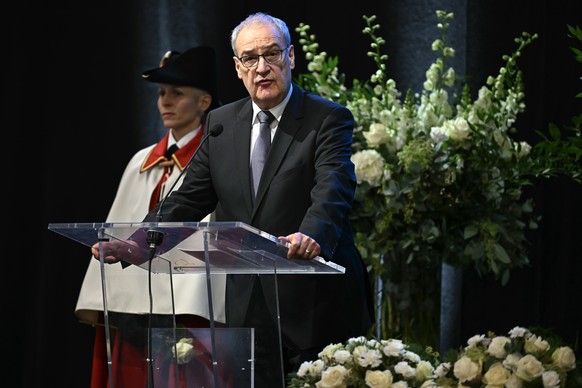 epa12638509 Swiss Federal President Guy Parmelin (R) delivers remarks during an official commemorative ceremony as part of a national day of mourning following the deadly fire at the 'Le Constell ...