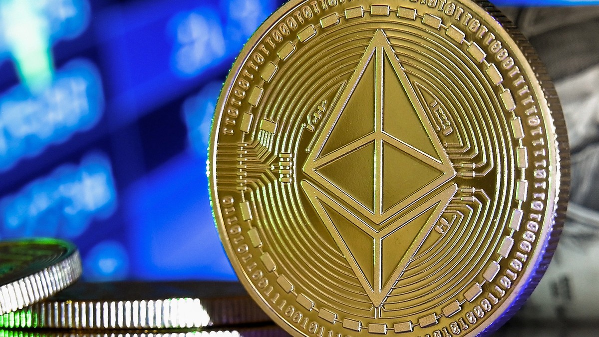 epa08951383 An Ethereum coin in front of a monitor showing a stock barometer in Duesseldorf, Germany, 20 January 2021. Cryptocurrency Bitcoin has experienced drastic ups and downs in recent weeks and  ...