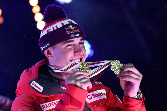 epa11891390 Franjo von Allmen of Switzerland poses with his gold medal of the Men?s Team Combined and his gold medal of Men?s Downhill race after the medal ceremony of the Men&#039;s Team Combined rac ...