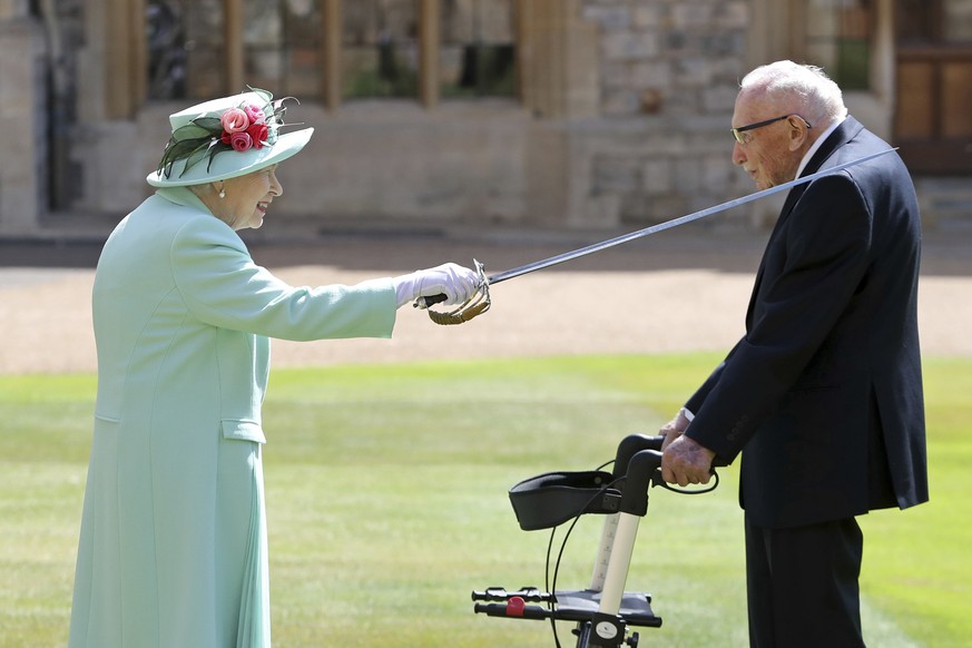 FILE - In this Friday, July 17, 2020 file photo, Captain Sir Thomas Moore receives his knighthood from Britain&#039;s Queen Elizabeth, during a ceremony at Windsor Castle in Windsor, England. Tom Moor ...