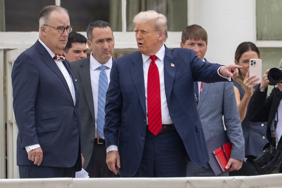 President Donald Trump, center, with architect James McCrery, left, surveys the grounds from the roof above the Colonnade that goes to the West Wing of the White House, Tuesday, Aug. 5, 2025, in Washi ...