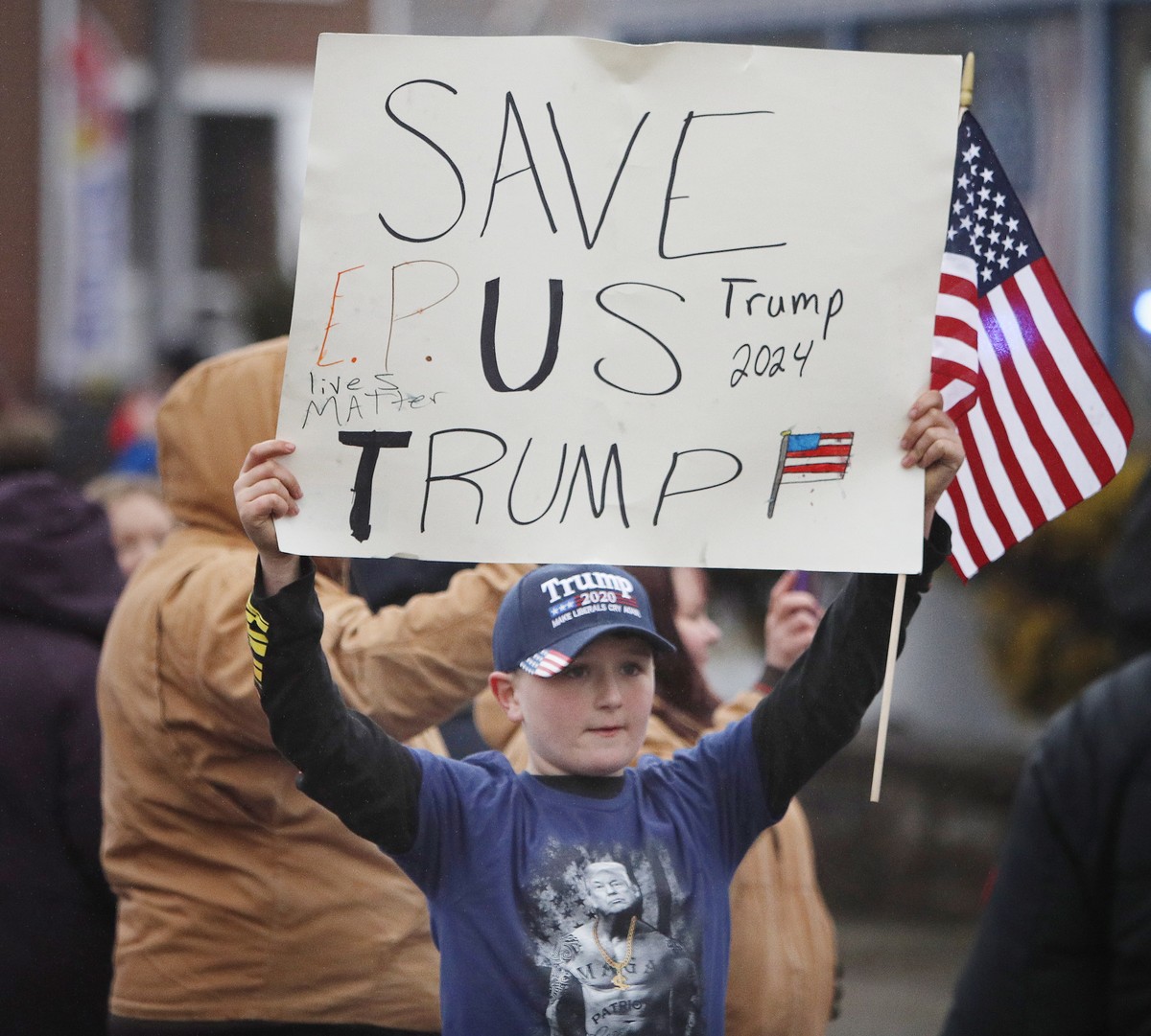 epa10484577 Supporters wait for former US President Donald Trump's arrival during his visit to the site of a train wreck and chemical spill in East Palestine, Ohio, USA, 22 February 2023. Trump i ...