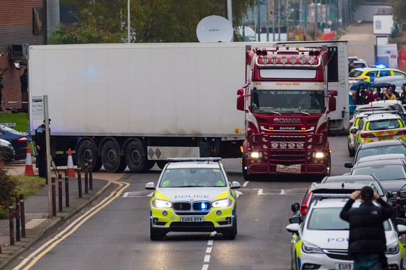 epaselect epa07943573 Police drive the lorry container along the road from the scene in Waterglade Industrial Park in Grays, Essex, Britain, 23 October 2019. A total of 39 bodies were discovered insid ...