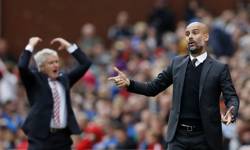 Britain Soccer Football - Stoke City v Manchester City - Premier League - bet365 Stadium - 20/8/16
Stoke City manager Mark Hughes reacts as Manchester City manager Pep Guardiola looks on
Action Imag ...