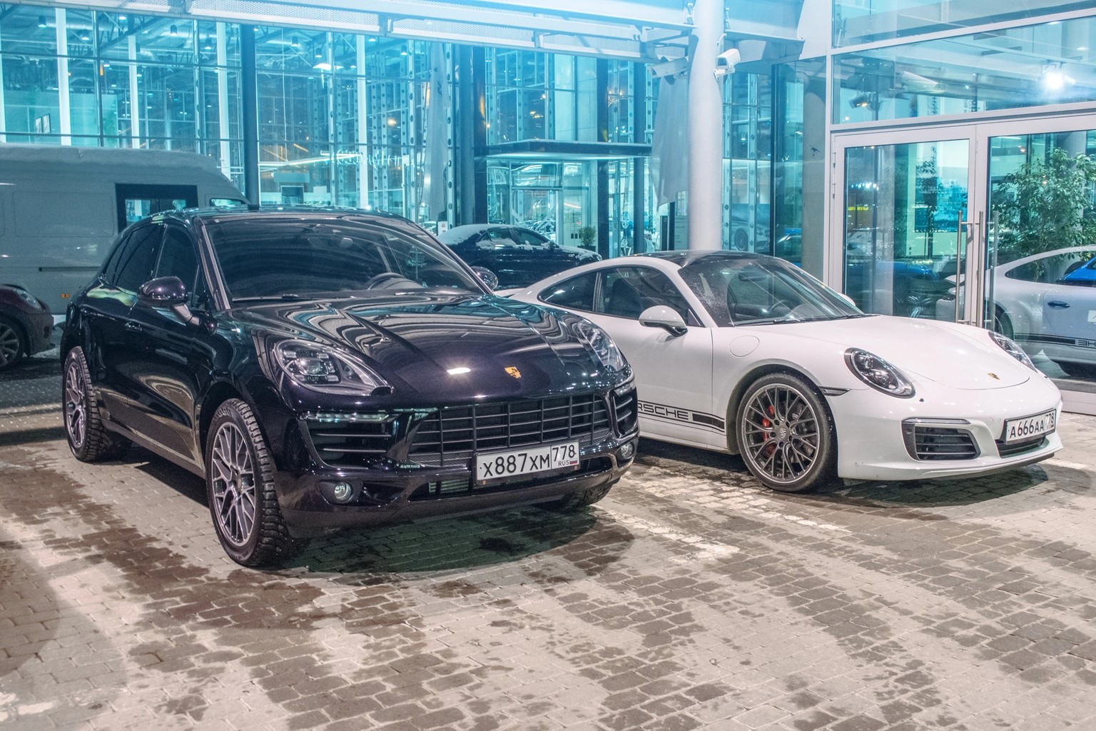 Porsche black Macan S and Porsche white 911 Carrera 4s. Russia, Saint-Petersburg. 02 March 2018