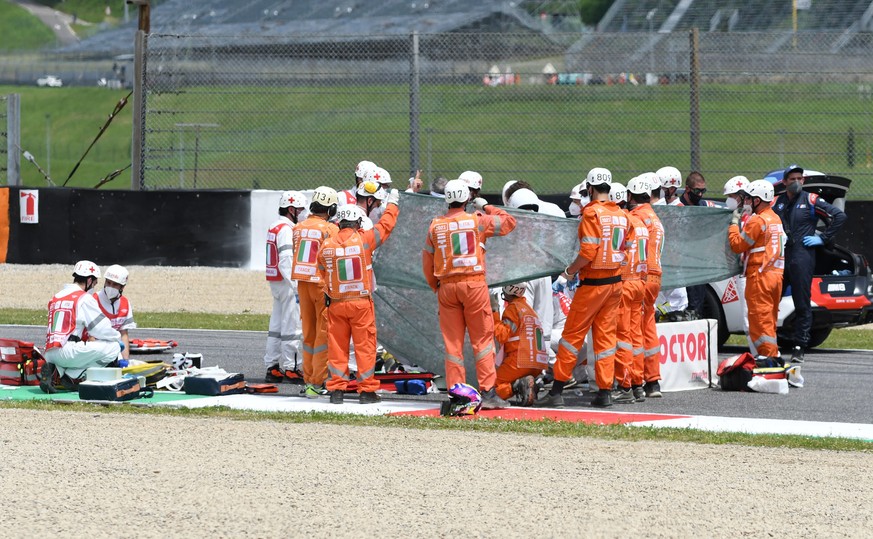 epa09235008 Swiss Jason Dupasquier of Moto3 receives medical assistance after crashing during the qualifying session of the Motorcycling Grand Prix of Italy at the Mugello circuit in Scarperia, centra ...