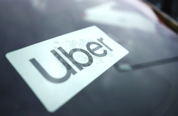 FILE - An Uber sign is displayed inside a car in Palatine, Ill., Thursday, Feb. 10, 2022. The U.S. Department of Labor is proposing a new rule on employee classifications, saying workers have incorrec ...