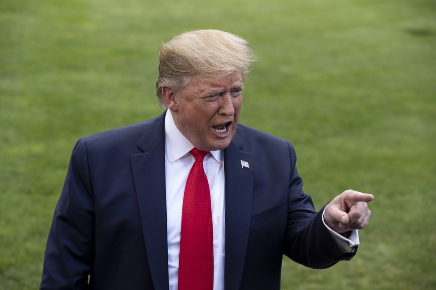 epa07738513 US President Donald J. Trump takes questions from members of the news media before departing the South Lawn of the White House by Marine One, in Washington, DC, USA, 24 July 2019. Before l ...