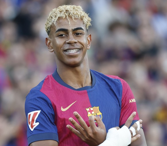 Barcelona&#039;s Lamine Yamal celebrates after scoring his side&#039;s first goal during the Spanish La Liga soccer match between Barcelona and Villarreal at Lluis Companys Olympic Stadium in Barcelon ...