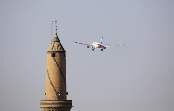 epa10892891 An Airbus A330 aircraft of Yemenia Airways flies near the minaret of a mosque while getting ready to land at Sana&#039;a airport, in Sana&#039;a, Yemen, 30 September 2023. Yemenia Airways  ...