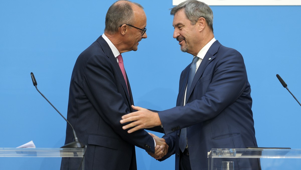 German opposition leader and Christian Democratic Union party chairman Friedrich Merz, left, and Markus Soeder, Christian Social Union party leader and state governor of Bavaria, shake hands at a join ...