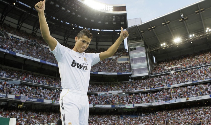 Real Madrid new soccer player Cristiano Ronaldo from Portugal waves to fans during his presentation at the Santiago Bernabeu stadium in Madrid on Monday, July 6, 2009. After a three-year wait, 80,000 ...