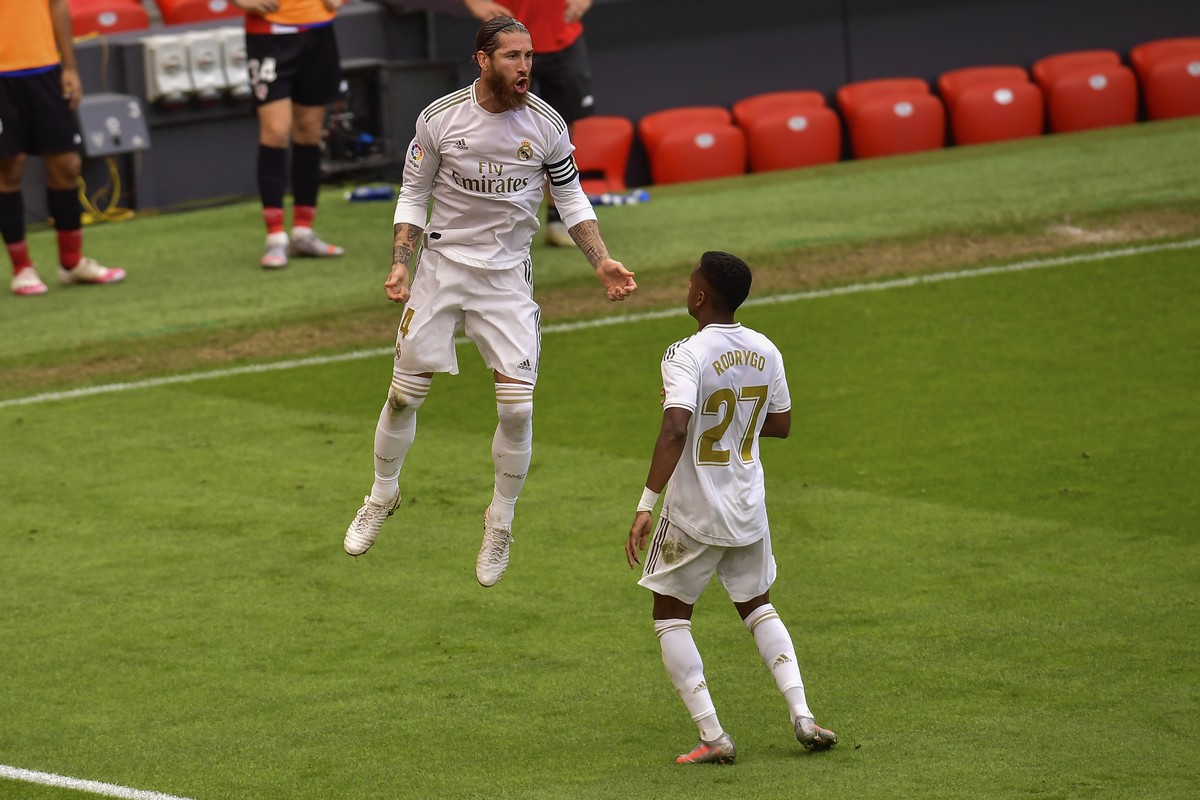 Real Madrid's Sergio Ramos, left, celebrates after scoring the opening goal from a penalty shoot during the Spanish La Liga soccer match between Athletic Club and Real Madrid at the San Manes sta ...