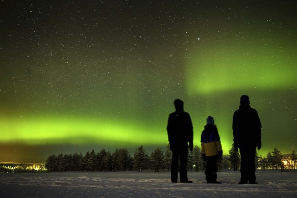 The northern lights, aurora borealis, illuminate the sky above the village of Akaslompolo in Kolari, beyond the Arctic Circle, Finnish Lapland, Sunday, Feb. 11, 2024. (Laurent Gillieron/Keystone via A ...