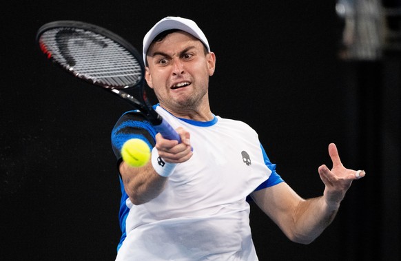 epa09681830 Aslan Karatsev of Russia in action during his match against Lorenzo Sonego of Italy on Day 4 of the Sydney Tennis Classic at Ken Rosewall Arena, in Sydney, Australia, 13 January 2022. EPA/ ...