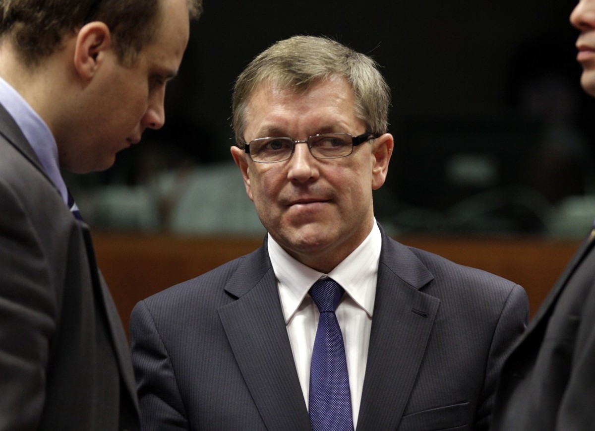 Hungary's Finance Minister Gyorgy Matolcsy, center, speaks with unidentified members of his delegation during a meeting of EU finance ministers at the EU Council building in Brussels on Tuesday,  ...