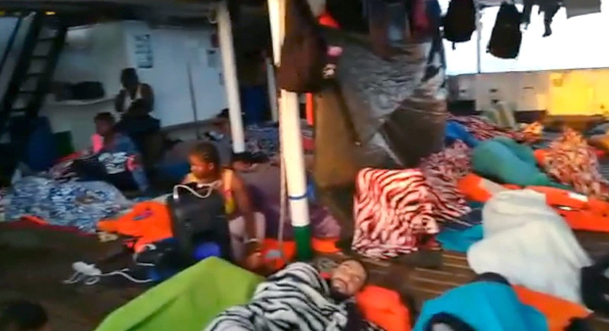 epa07773180 A handout photo made available by Spanish NGO Open Arms shows some of the 151 migrants on board the Open Arms' ship in Lampedusa island, in Italy, 14 August 2019. Italy's Governm ...