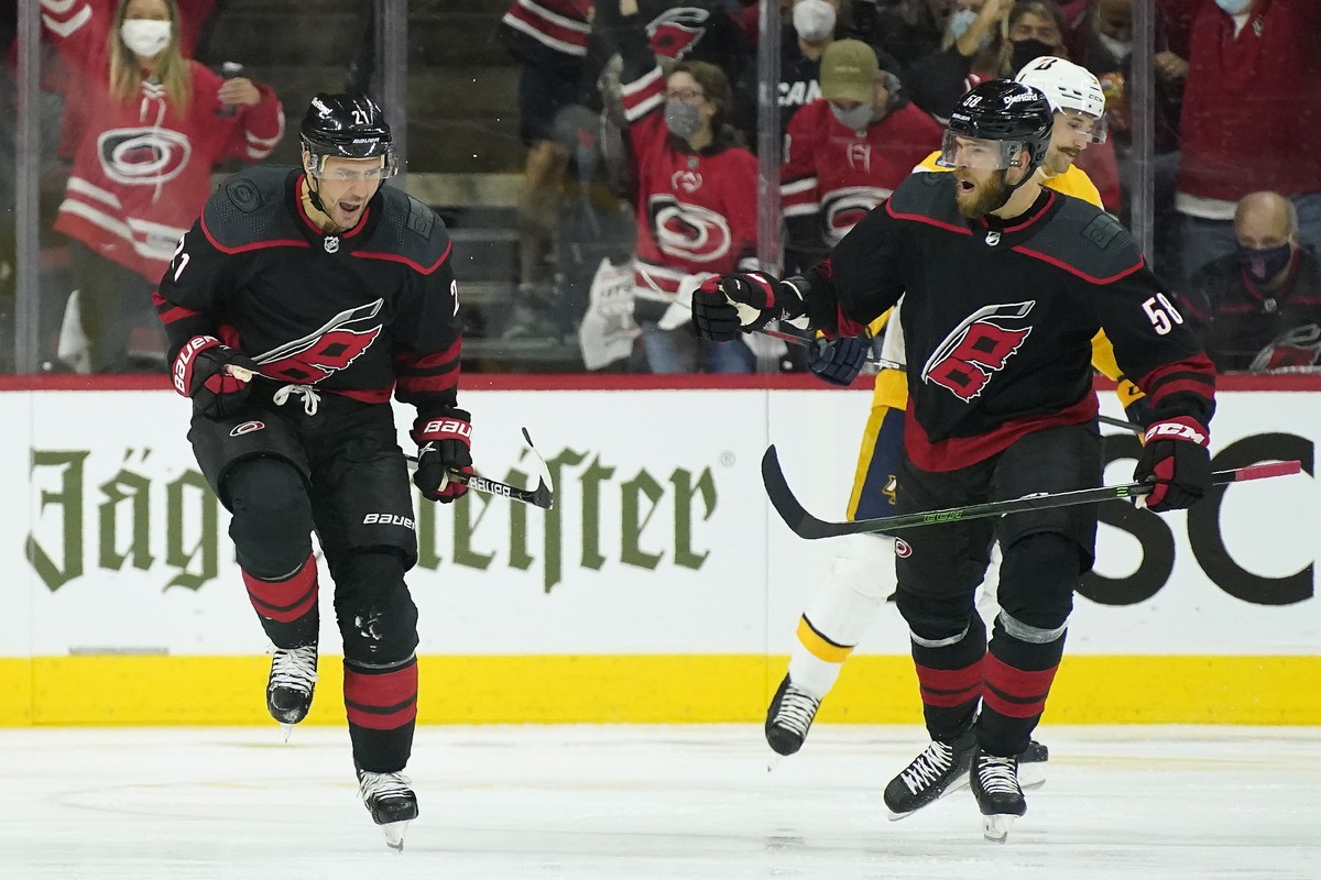 Carolina Hurricanes right wing Nino Niederreiter (21) and defenseman Jani Hakanpaa (58) celebrate Niederreiter's goal against the Nashville Predators during the third period in Game 1 of an NHL h ...