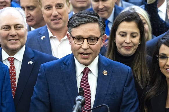 epa10937419 Republican lawmaker from Louisiana Mike Johnson (C), surrounded by fellow Republicans, speaks to reporters after they voted him as their next speaker nominee in the Longworth House Office  ...