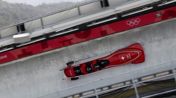Driver Rico Peter, Michael Kuonen, Simon Friedli and Thomas Amrhein of Switzerland take a curve during training for the four-man bobsled competition at the 2018 Winter Olympics in Pyeongchang, South Korea, Friday, Feb. 23, 2018. (AP Photo/Andy Wong)