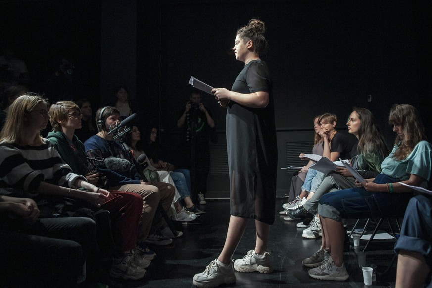 In this photo taken on Thursday, July 27, 2019, Syuyumbike Davlet-Kildeyeva, center, speaks at a performance to support Khachaturyan sisters, in Moscow, Russia. Performers at Theater Doc last week wer ...