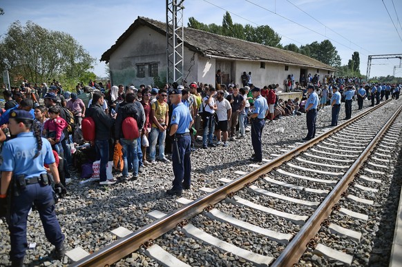 TOVARNIK, CROATIA - SEPTEMBER 17: Migrants wait at Tovarnik station to board a train bound for Zagreb on September 17, 2015 in Tovarnik, Croatia. Migrants are now diverting to Croatia from Serbia afte ...