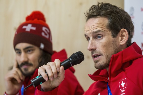 Eric Blum of Switzerland and Switzerland&#039;s head coach Patrick Fischer, from left, during a media conference of the Swiss men ice hockey national team in the House of Switzerland at the XXIII Wint ...