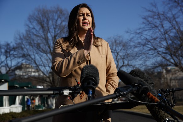 White House press secretary Sarah Sanders speaks with reporters outside the White House, Tuesday, Feb. 5, 2019, in Washington. (AP Photo/ Evan Vucci)