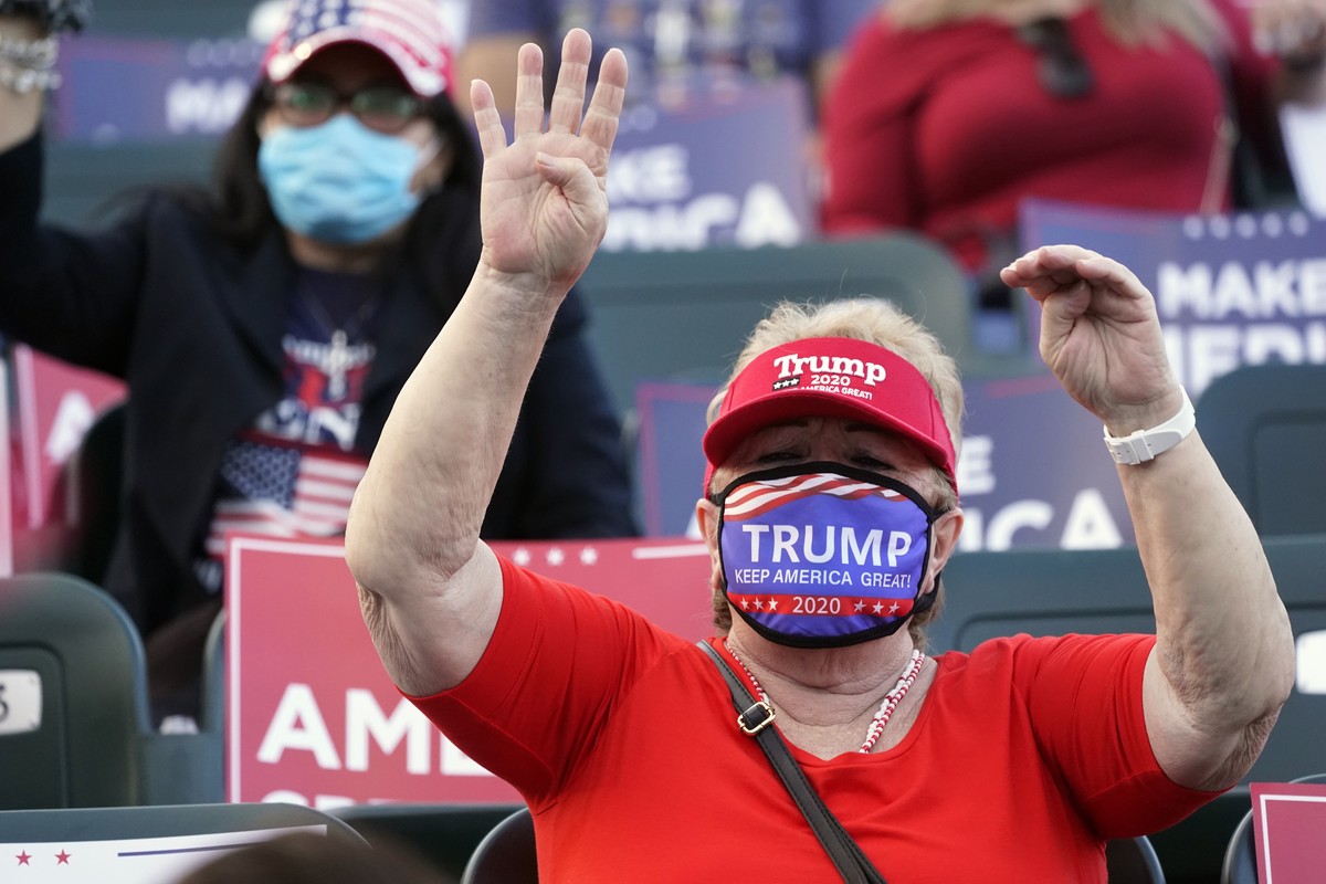 A supporter of President Donald Trump chants "Four more years!" during a "Make America Great Again!" event with Ivanka Trump at Bayfront Park Amphitheater, Tuesday, Oct. 27, 2020,  ...