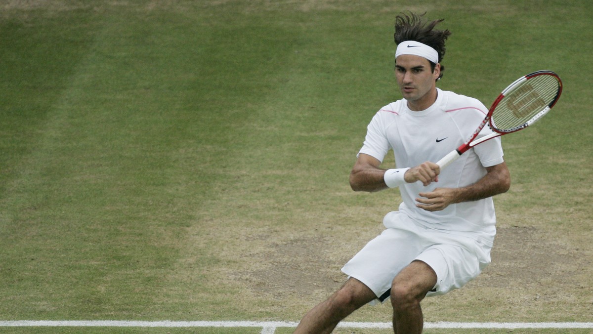Defending champion Roger Federer of Switzerland returns a shot from Mario Ancic of Croatia, during their Men's Singles, quarterfinal match, on Wimbledon's Centre Court, Wednesday, July 5, 20 ...