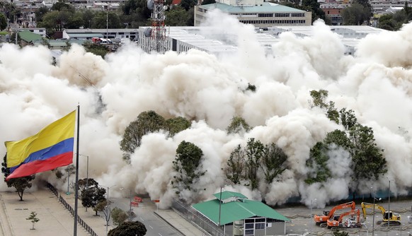 epa09322464 View of the Colombian Defense Ministry during the implosion in Bogota, Colombia, 04 July 2021. The Colombian authorities imploded the building that was the headquarters of the Ministry of  ...