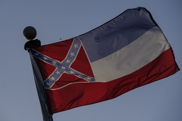 epa08519196 The flag of the state of Mississippi flies against a setting sun over the state