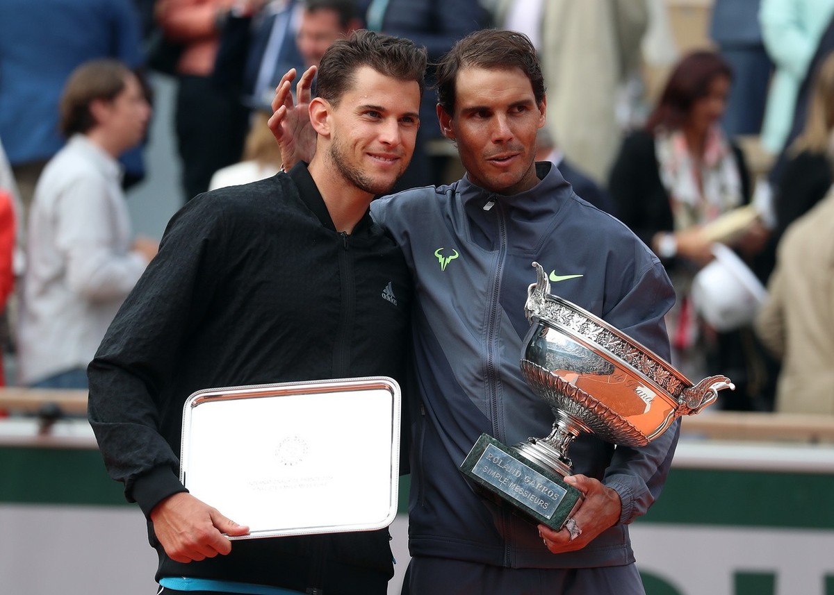 epa07637425 Winner Rafael Nadal of Spain (R) and runner-up Dominic Thiem of Austria pose with their trophies after their men's final match during the French Open tennis tournament at Roland Garro ...