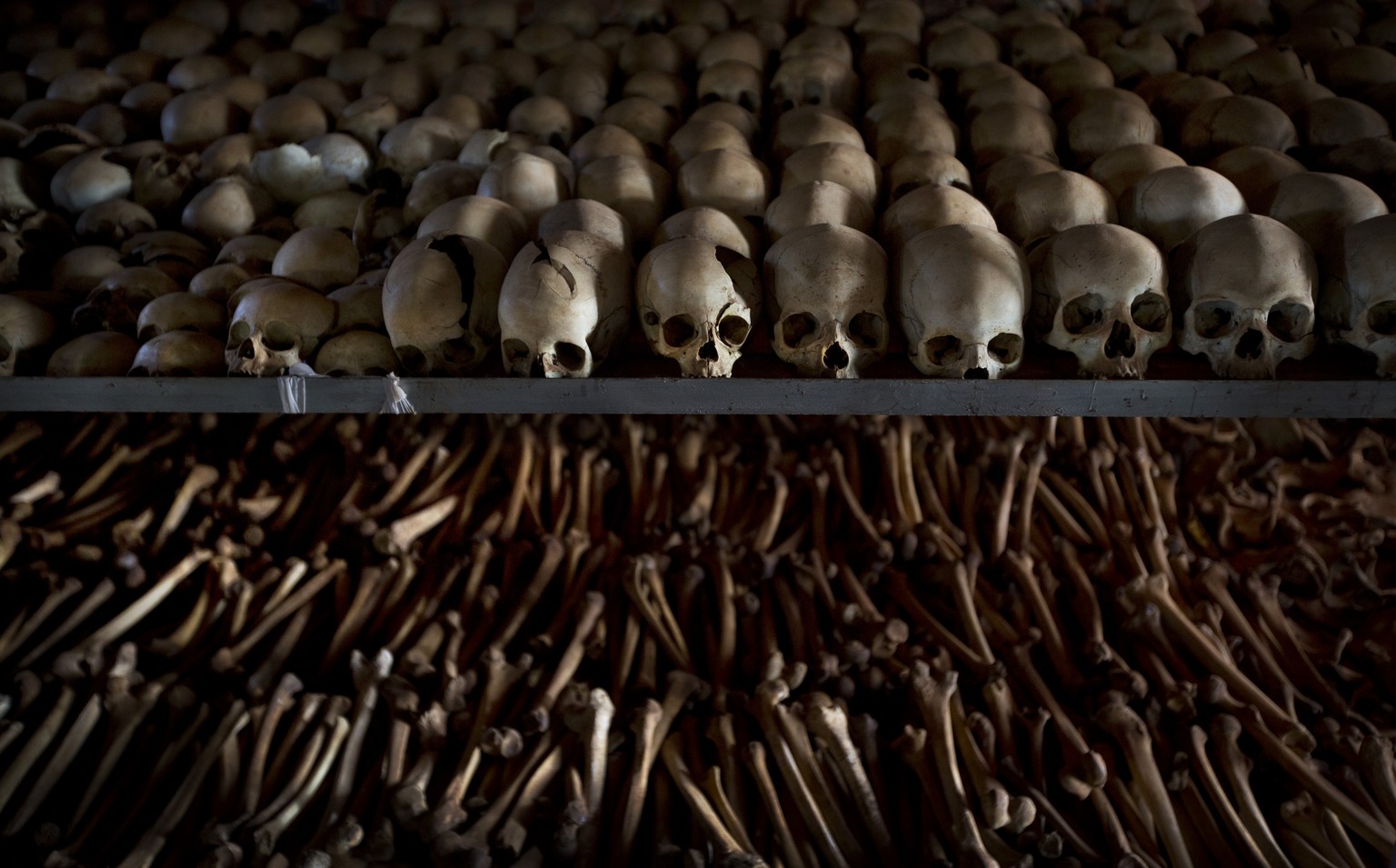 FILE - In this Friday, April 4, 2014 file photo, the skulls and bones of some of those who were slaughtered as they sought refuge inside the church are laid out as a memorial to the thousands who were ...