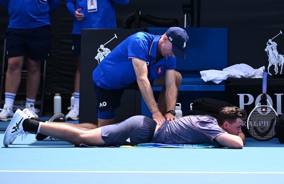 epa11821277 Dominic Stricker of Switzerland recieves medical attention during a break in action against James Duckworth of Australia during their first round match during the 2025 Australian Open tenn ...