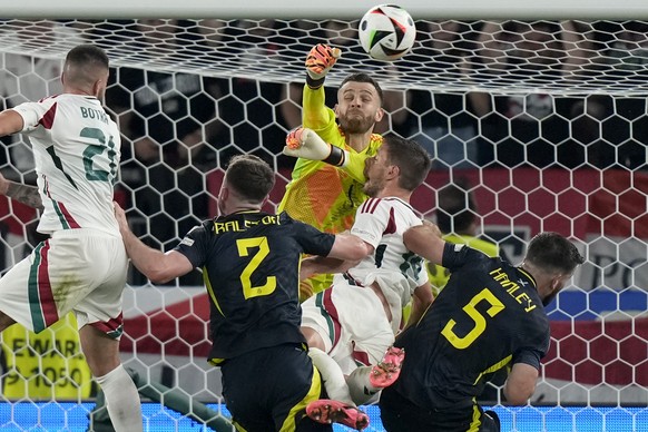 Scotland&#039;s goalkeeper Angus Gunn, up, and Hungary&#039;s Barnabas Varga, center, collide during a Group A match between Scotland and Hungary at the Euro 2024 soccer tournament in Stuttgart, Germa ...