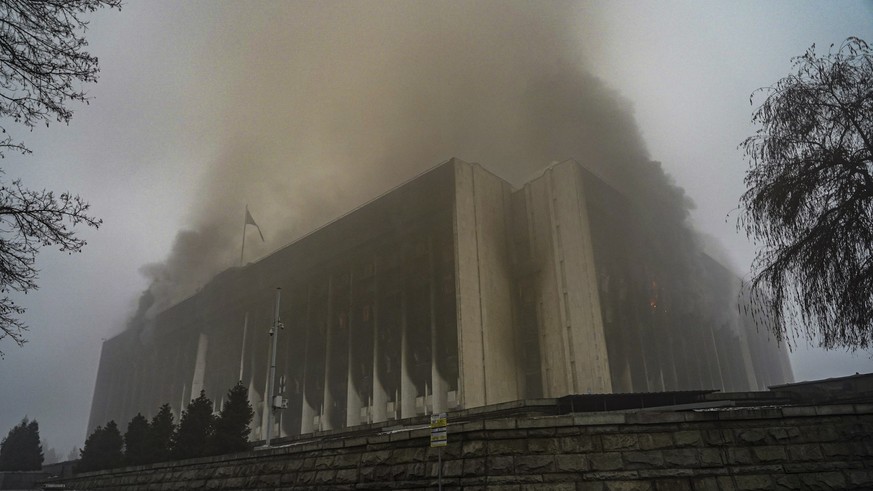epa09676186 Almaty City Administration building burns during the protests over a hike in energy prices in Almaty, Kazakhstan, 06 January 2022 (issued 09 January 2022). Protesters stormed the mayor's o ...