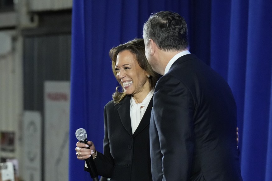 Democratic presidential nominee Vice President Kamala Harris, left, and second gentleman Doug Emhoff visit a watch party at Cherry Street Pier after the presidential debate in Philadelphia, Tuesday, S ...