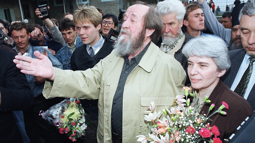 FILE - Russian writer Alexander Solzhenitsyn, flanked by his wife Natalia, right, and his son Yermolai, left, addresses reporters and people on his arrival at Vladivostok Airport on May 27, 1994. Nobe ...