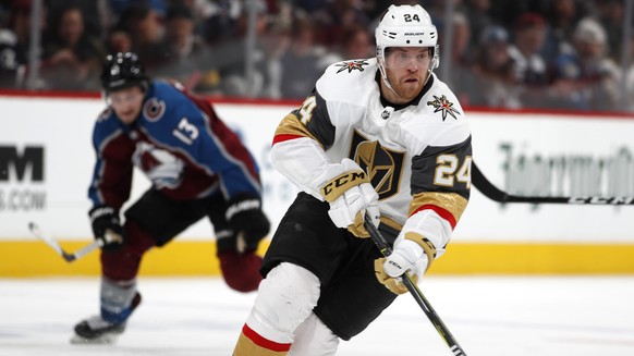 Vegas Golden Knights center Oscar Lindberg, front, drives down the ice with the puck as Colorado Avalanche center Alexander Kerfoot pursues in the second period of an NHL hockey game Monday, Feb. 18,  ...