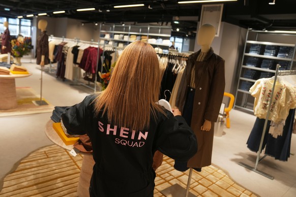 An employee arranges clothes at the BHV department store where fast fashion powerhouse Shein's first permanent store is set to open, Wednesday, Nov. 5, 2025 in Paris. (AP Photo/Thibault Camus)
Fr ...