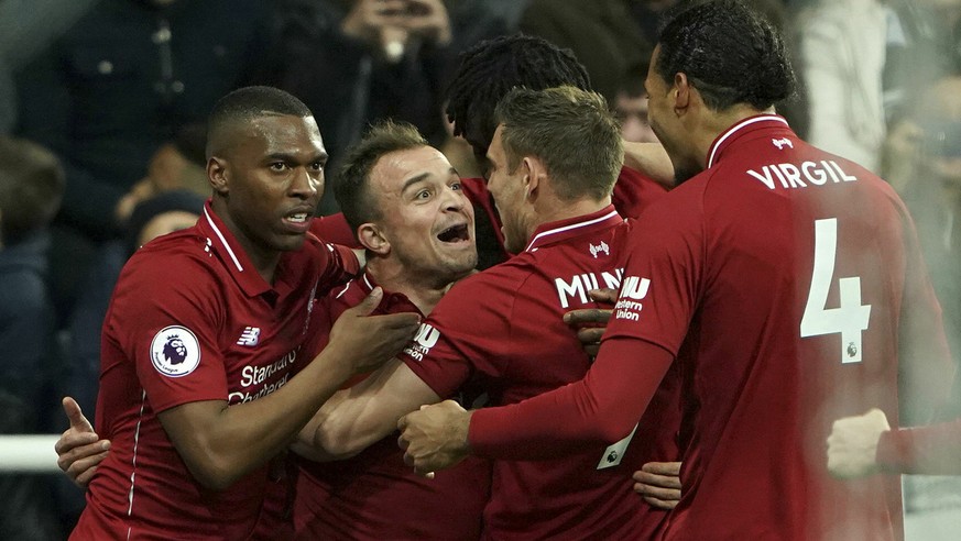 Liverpool players celebrate after Divock Origi, obscured, scored their third goal against Newcastle United during the Premier League soccer match at St James&#039; Park, in Newcastle, England, Saturda ...