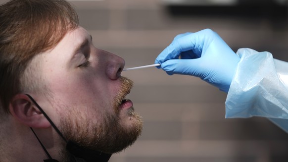Clay Harris receives a COVID-19 test outside the Salt Lake County Health Department Friday, July 22, 2022, in Salt Lake City. (AP Photo/Rick Bowmer)