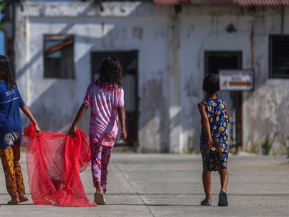 THITU ISLAND, DISPUTED SOUTH CHINA SEA - MAY 3: Children transfer their fish catches, on Manila-ruled Thitu Island in the disputed South China Sea, on May 3, 2026. The Philippine-ruled Thitu Island, a ...