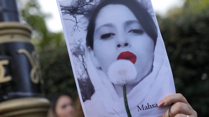 Demonstrators hold placards outside the Iranian Embassy in London, Sunday, Sept. 25, 2022. They were protesting against the death of Iranian Mahsa Amini, a 22-year-old woman who died in Iran while in  ...