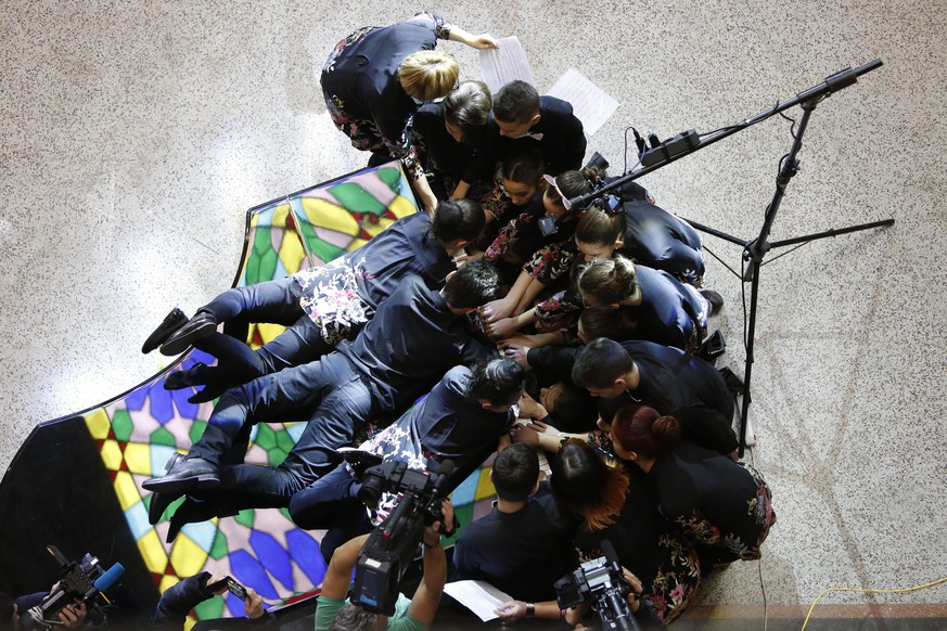 Twenty Bosnian children play &quot;Galop Marche&quot;, a classical piece by Albert Lavignac, in an attempt to set a Guinness record in largest number of people performing a single composition on a pia ...