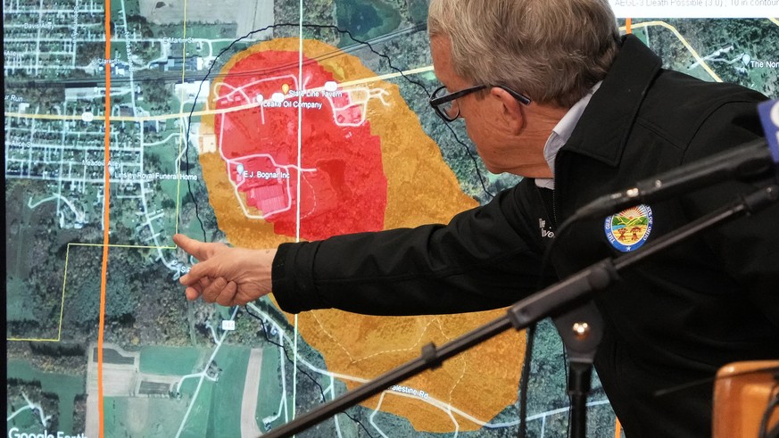 Ohio Governor Mike DeWine points to a map of East Palestine, Ohio that indicates the area that has been evacuated as a result of Norfolk and Southern train derailment, after touring the site, Monday,  ...