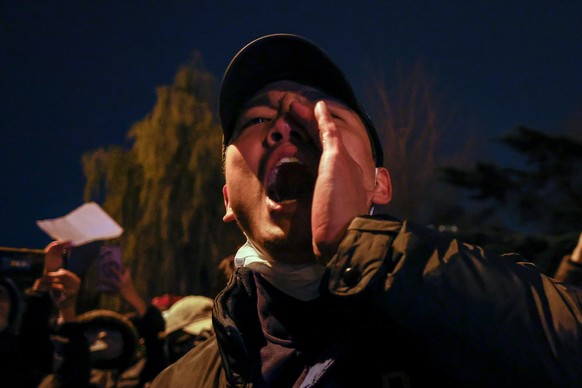 epa10333058 A man shouts during a protest triggered by a fire in Urumqi that killed 10 people in Beijing, China, 27 November 2022. Protests against China&#039;s strict COVID-19 restrictions have erupt ...