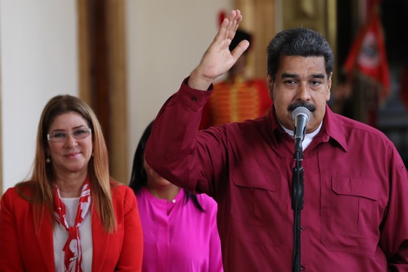 epa06753167 Venezuelan President Nicolás Maduro (R) speaks accompanied by his wife Cilia Flores (L) during a press conference at the Miraflores Palace in Caracas, Venezuela, on 20 May 2018. Venezuela  ...